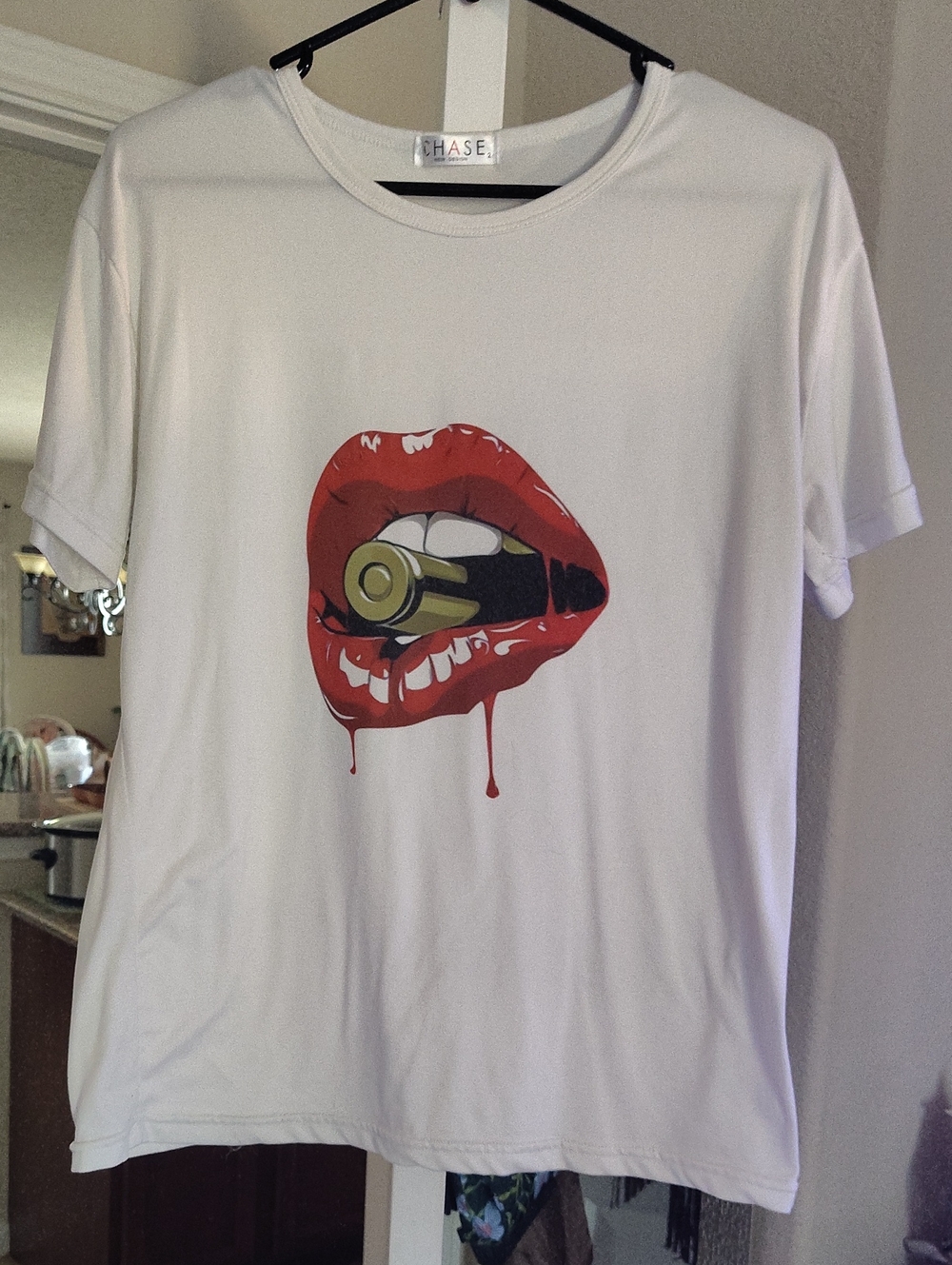 Chaser White Tee with Red Lip and Gold Bullet Graphic